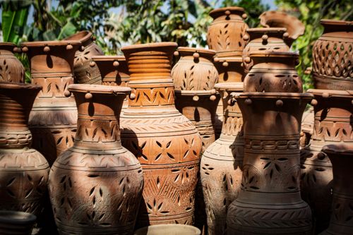 Free A collection of traditional handmade clay vases illuminated by sunlight, showcasing intricate designs. Stock Photo