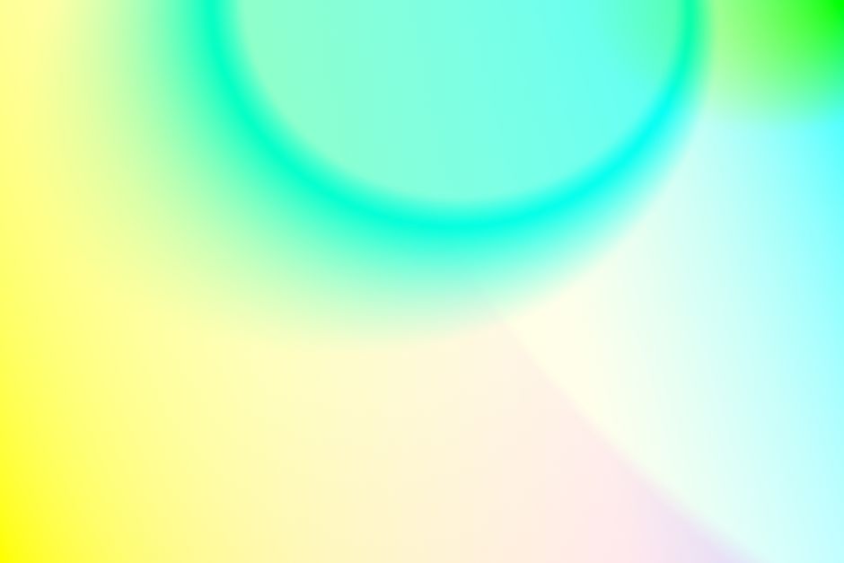 A vivid abstract gradient with blue, green, and yellow tones creating a soft, colorful backdrop.