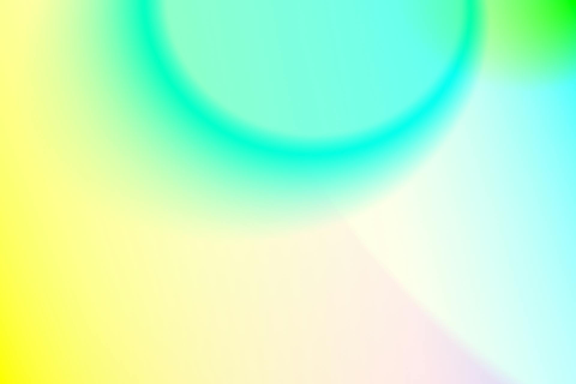 A vivid abstract gradient with blue, green, and yellow tones creating a soft, colorful backdrop.