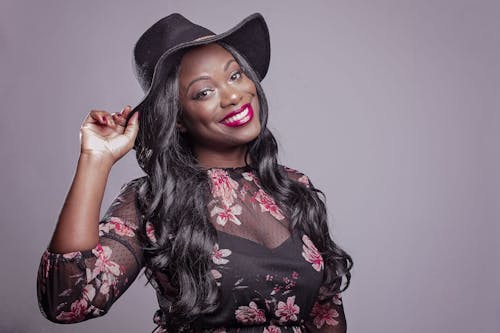 Smiling Woman Holding Black Hat