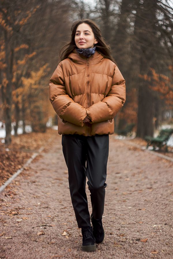 Woman in a cropped puffer jacket with high-waisted joggers