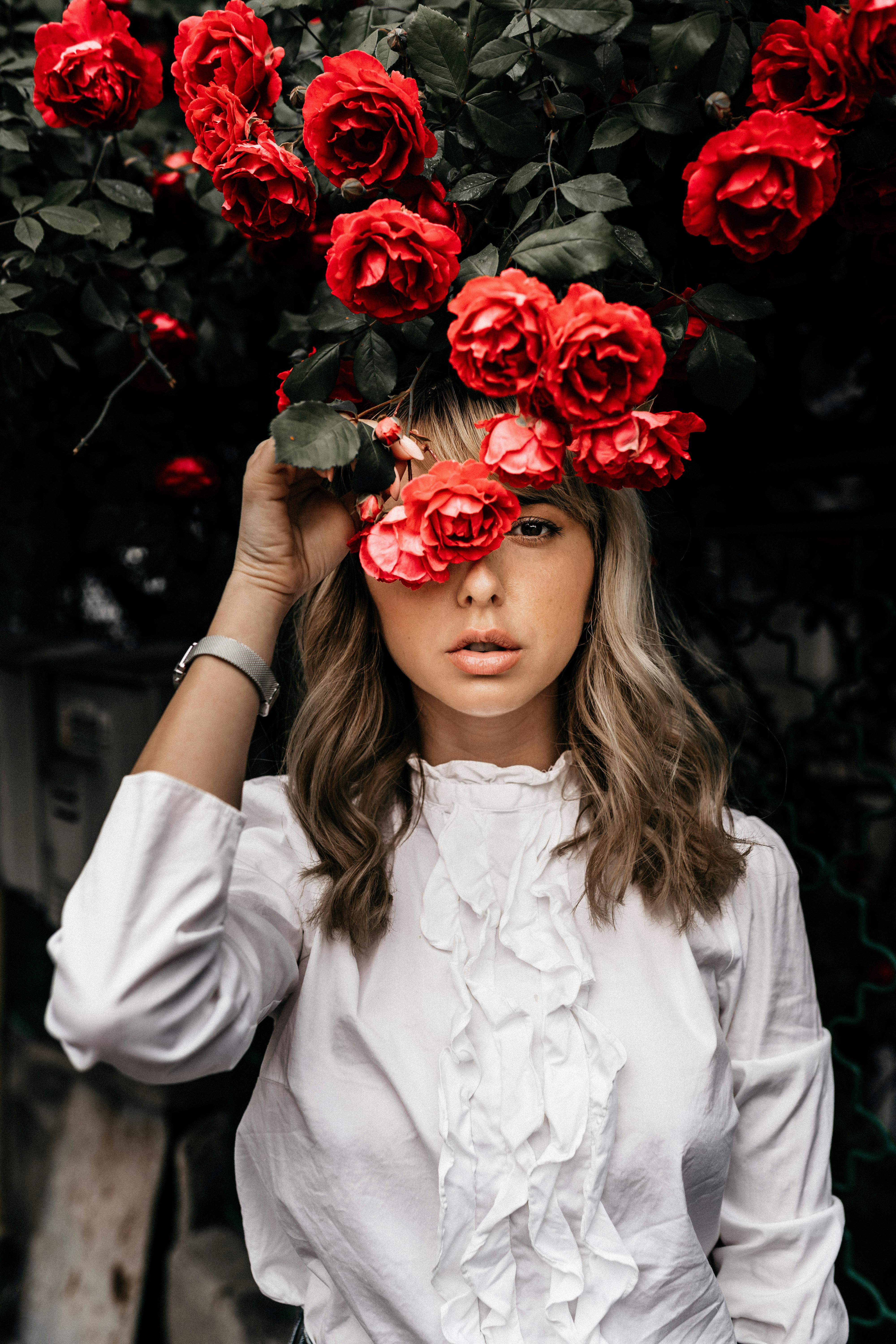 stylish woman near blooming roses