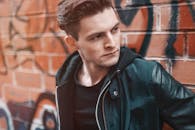 一位年轻时尚的人在涂鸦墙前摆姿势的肖像