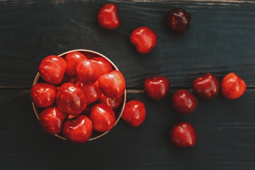 Free Ripe healthy acerola cherries scattered on table Stock Photo