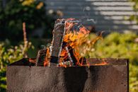 Burning fire at campsite on sunny day
