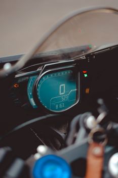Digital dashboard view of motorcycle speedometer displaying zero speed.