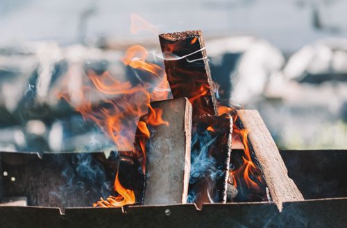 Free Pile of dry cut wood in bright wavy flame in metal container on blurred background Stock Photo