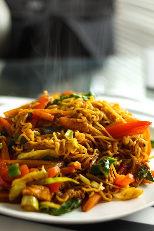 Hot Chow Mein Noodles in White Ceramic Plate