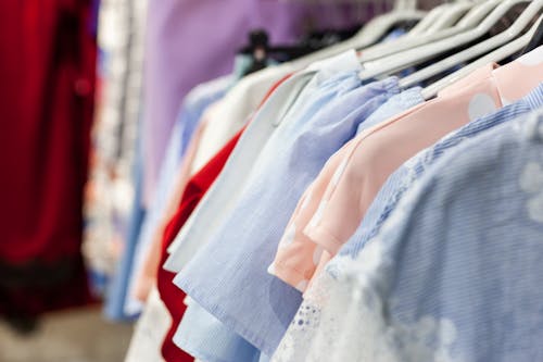 Collection of blouses on hangers in shop