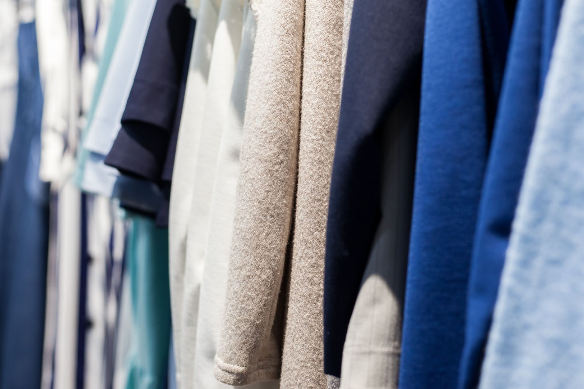 Capsule wardrobe garment pieces arranged into two distinct colour-temperature clusters — warm neutrals and cool neutrals — illustrating how undertone grouping affects outfit pairing potentialSOURCE: Pexels | Unsplash