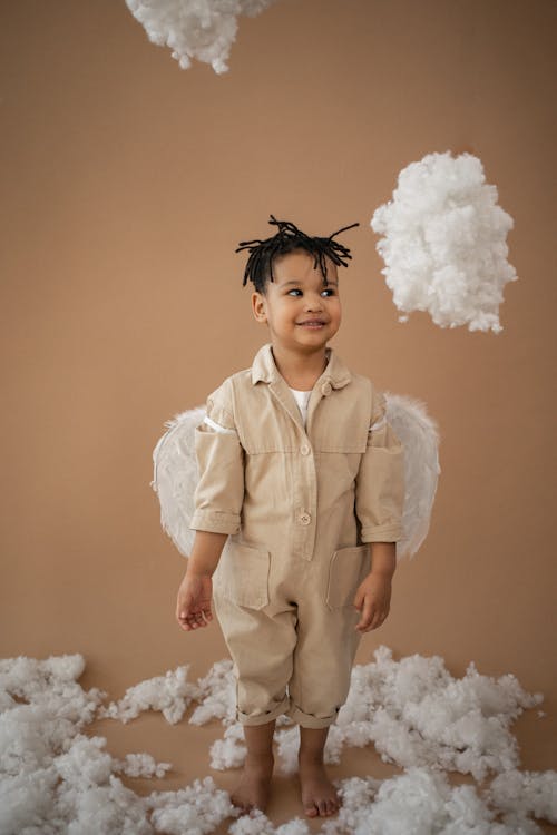 Content black boy in angel costume