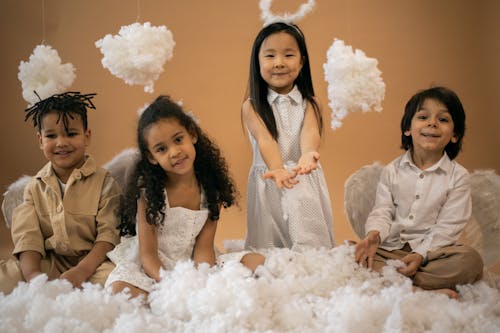 Happy diverse kids in angel outfits