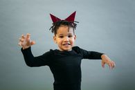 Black boy in devil costume