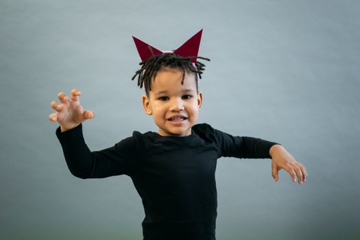 Black boy in devil costume