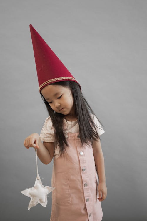 Asian Asian girl in gnome cap with star in hand