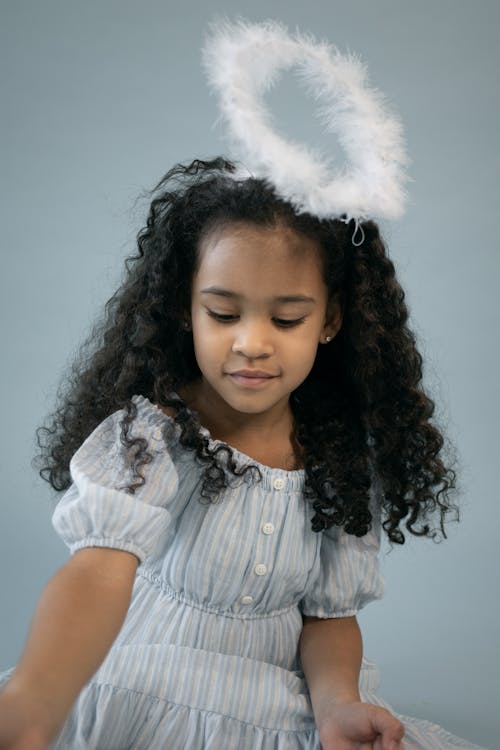 Cute black girl in angel costume