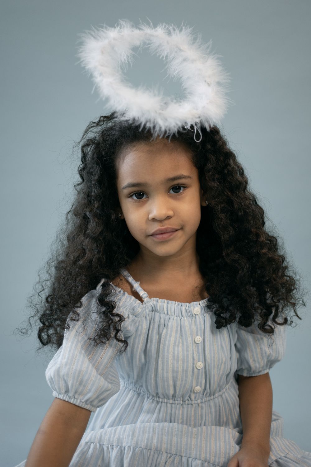 Adorable black girl in angel outfit with halo · Free Stock Photo