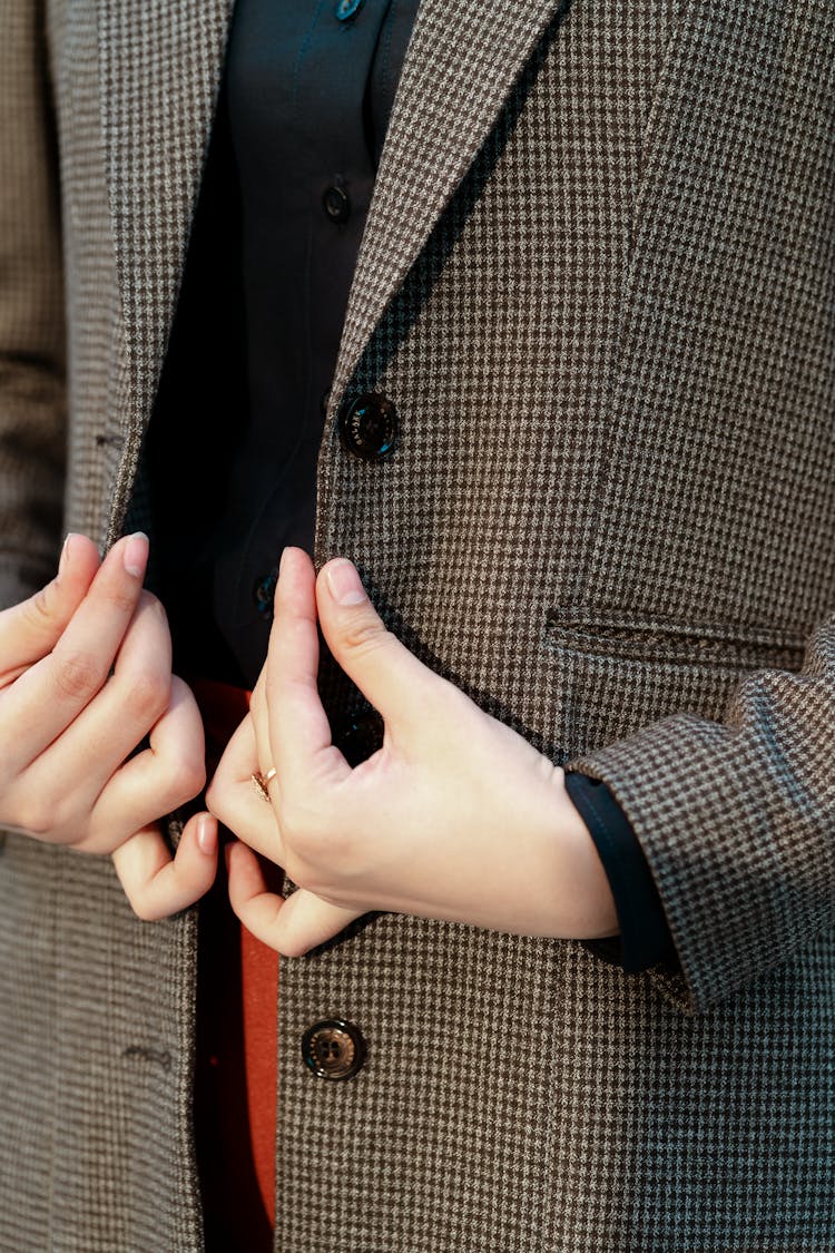 A Person In A Houndstooth Patterned Suit Jacket