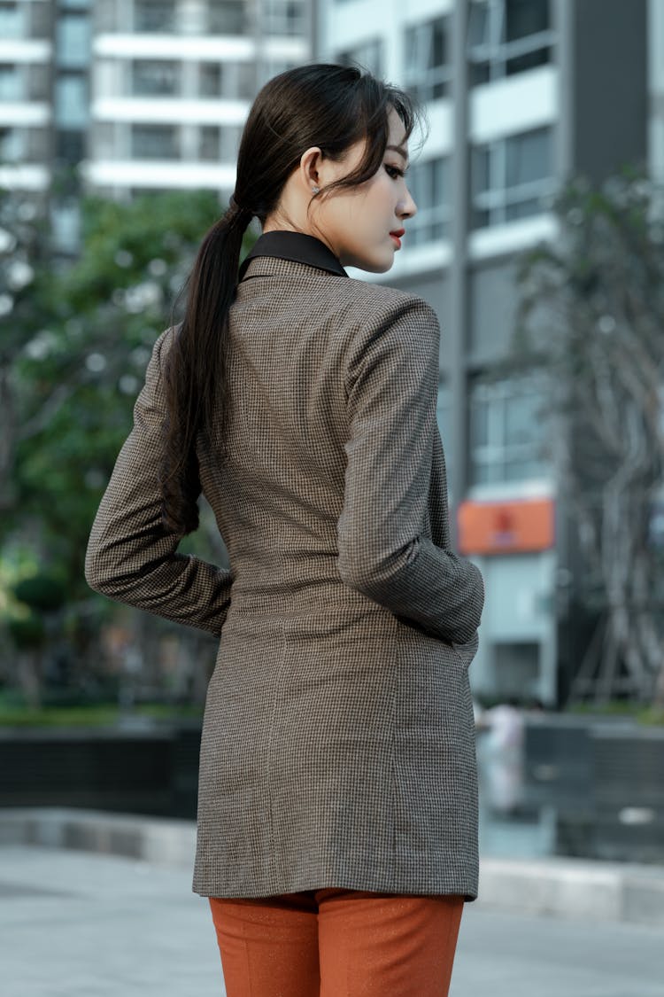 A Woman In A Houndstooth Patterned Suit Jacket