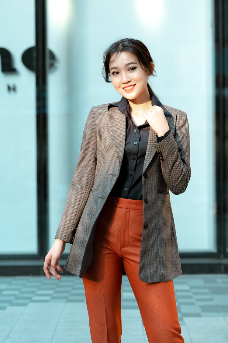 A Woman In A Houndstooth Patterned Suit Jacket