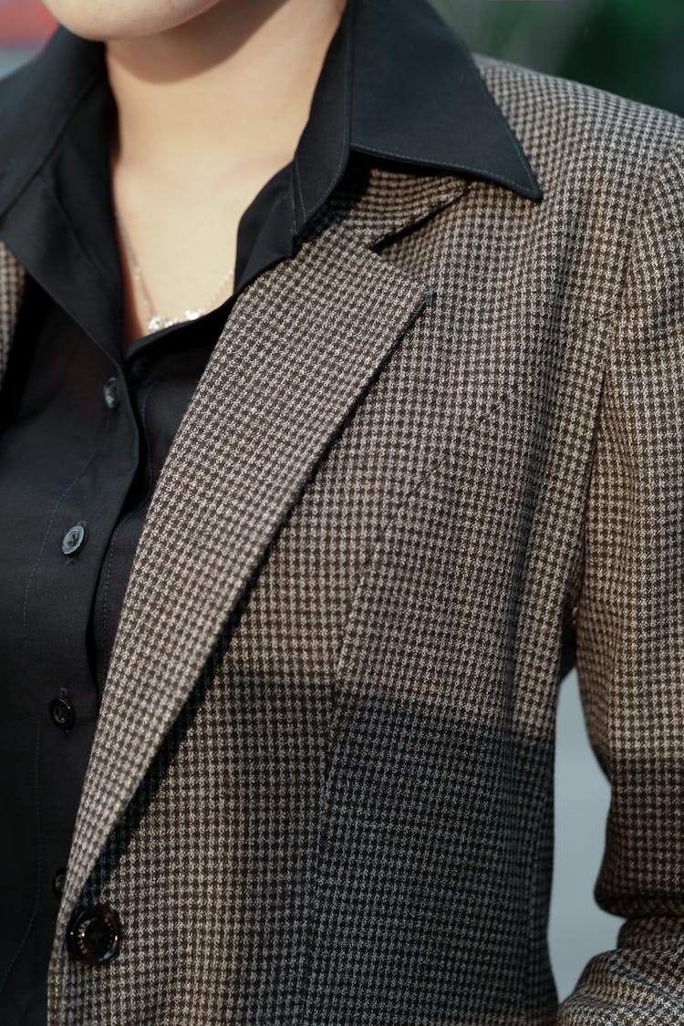 A Person In A Houndstooth Patterned Suit Jacket