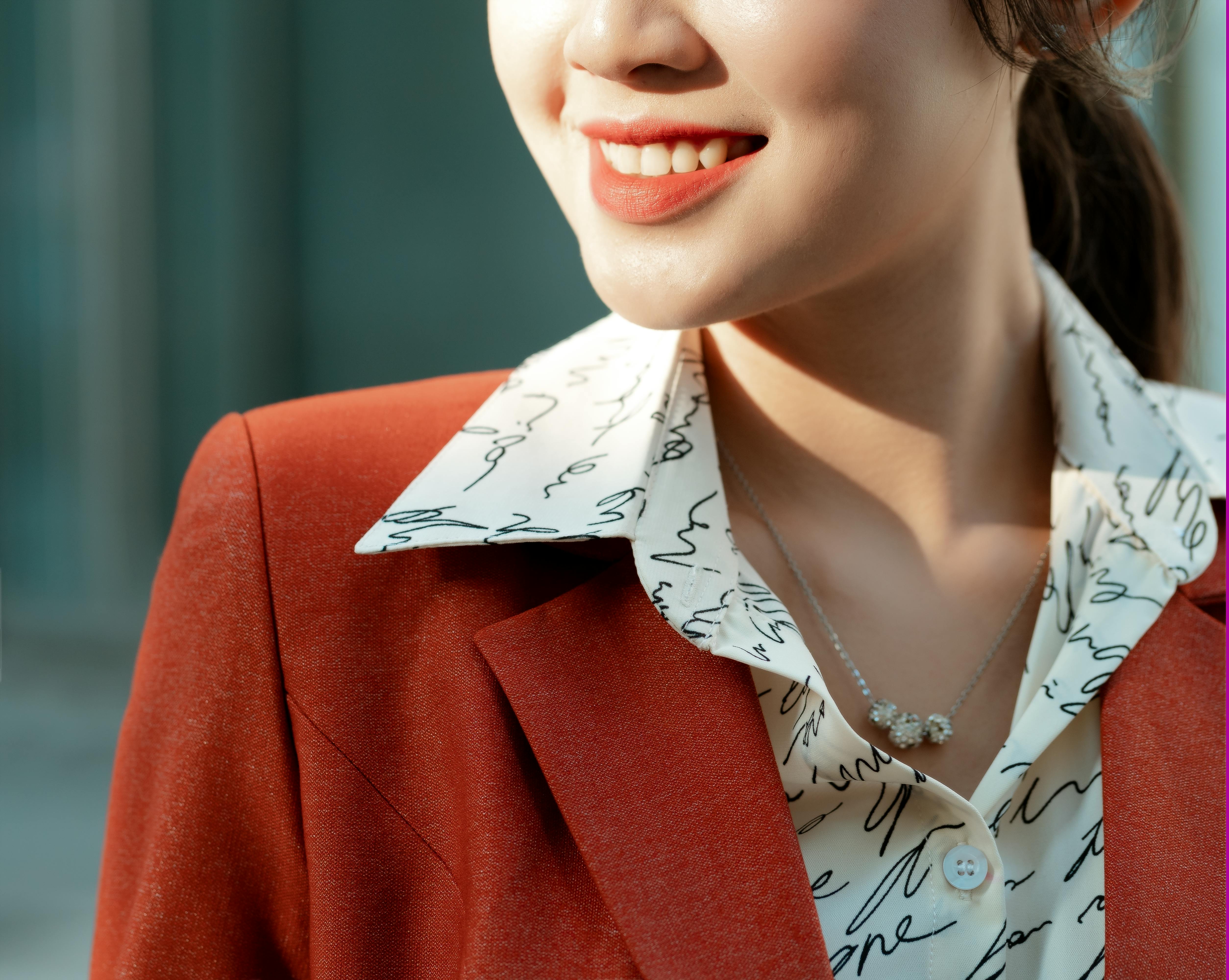 woman in a red blazer smiling