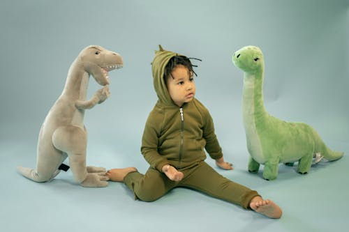 Free Cute black boy near dinosaurs toys Stock Photo