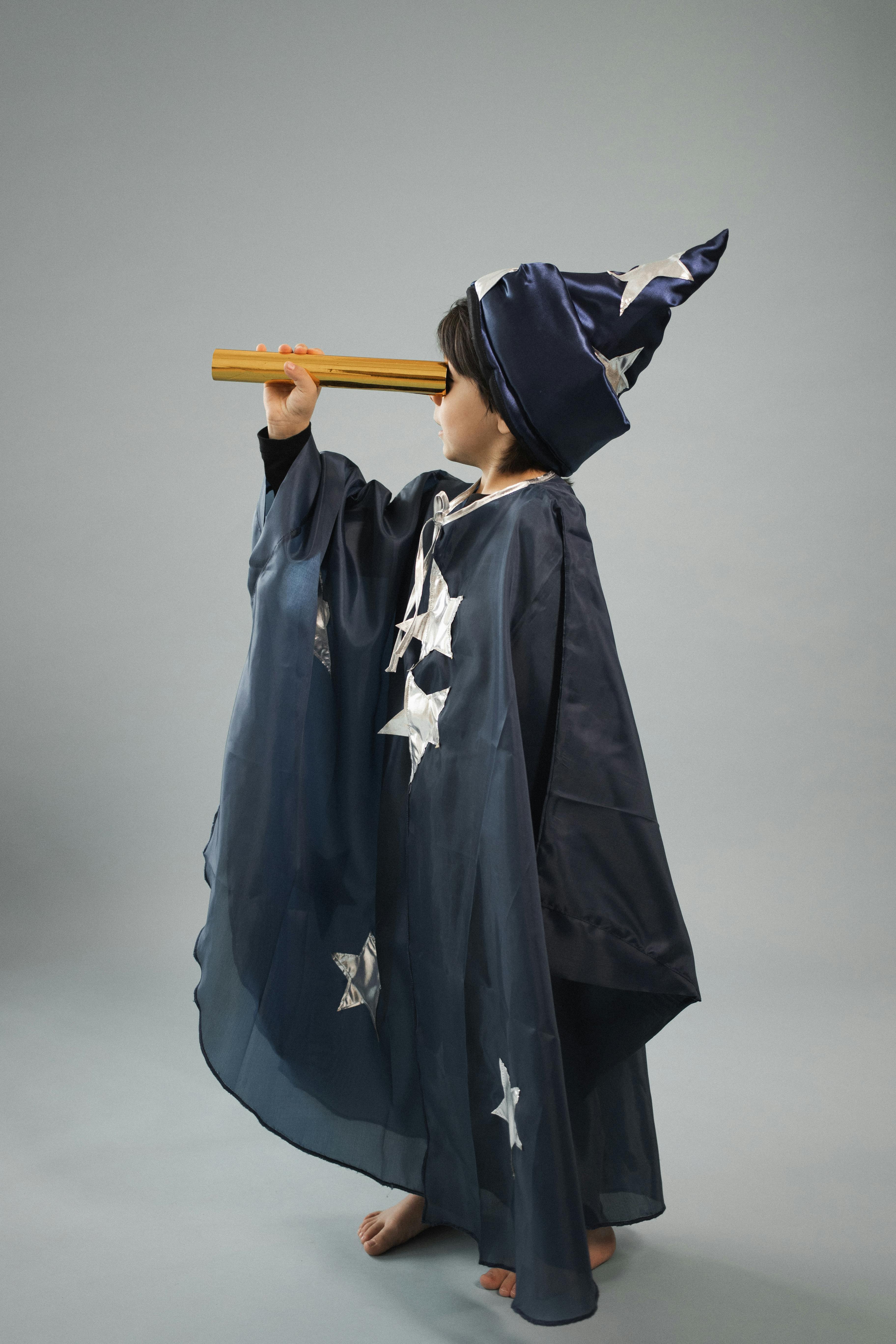 boy in astrologer costume with telescope