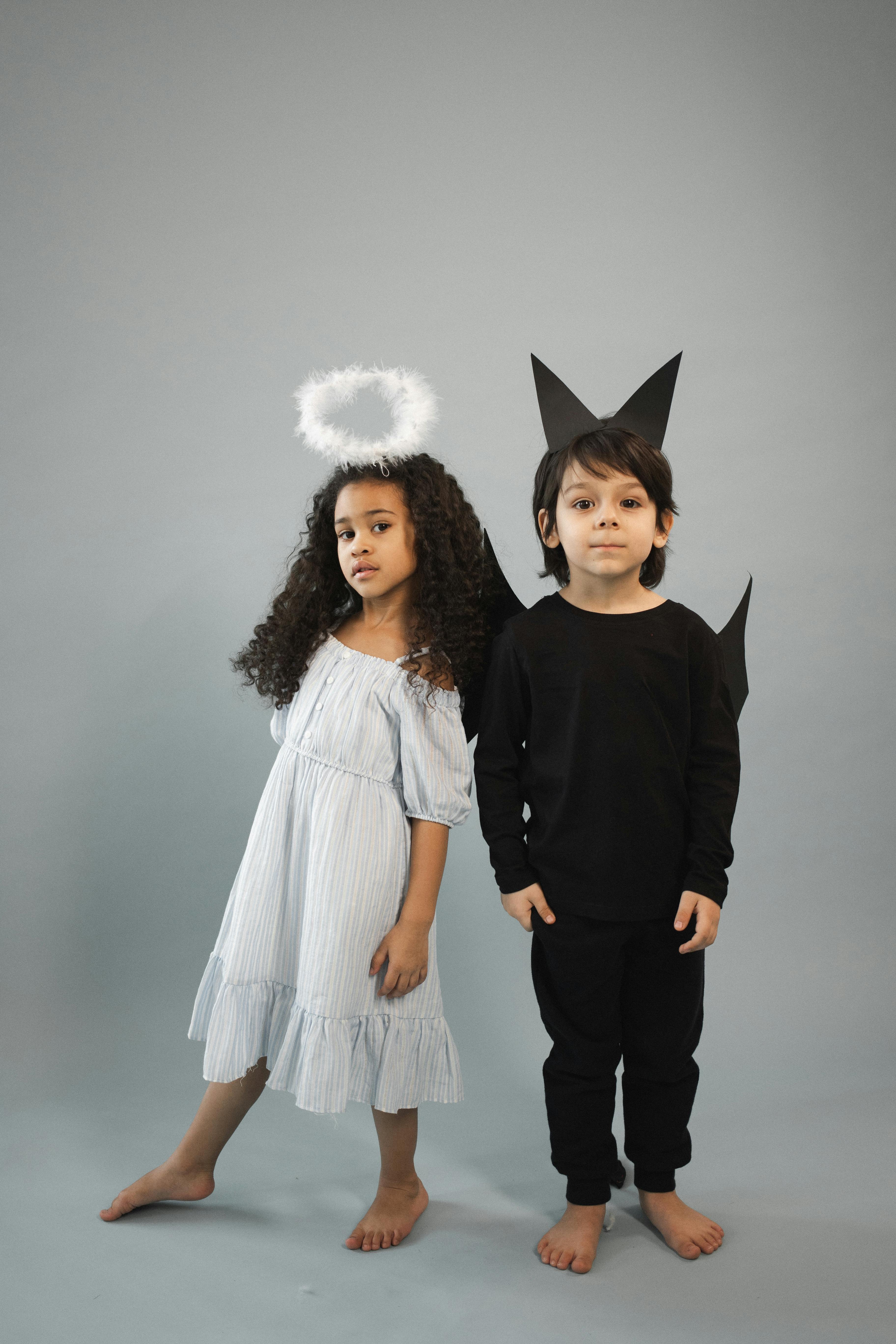 Cute diverse kids in angel and bat costumes · Free Stock Photo