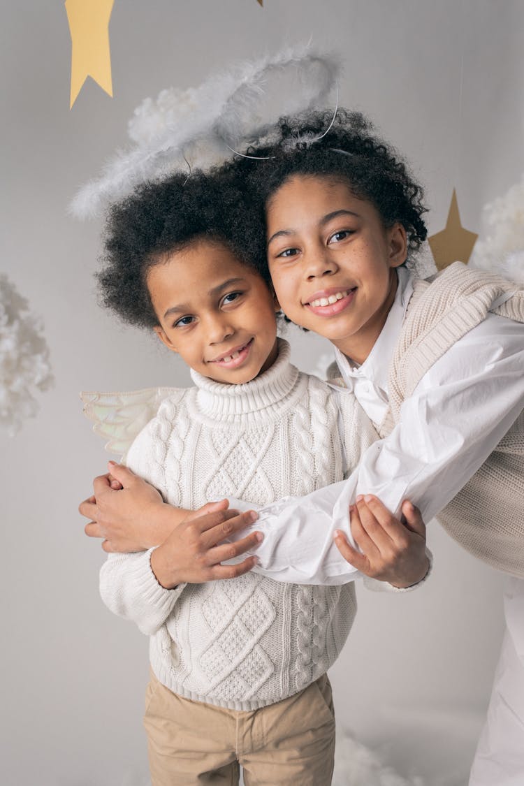 Black Girl Embracing Brother In Angel Costume