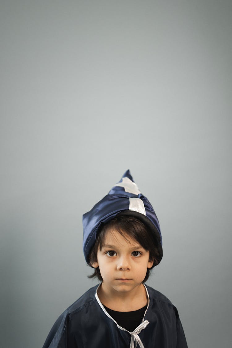 Cute Little Boy In Halloween Costume In Studio