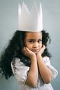 Cute black girl in princess outfit in studio