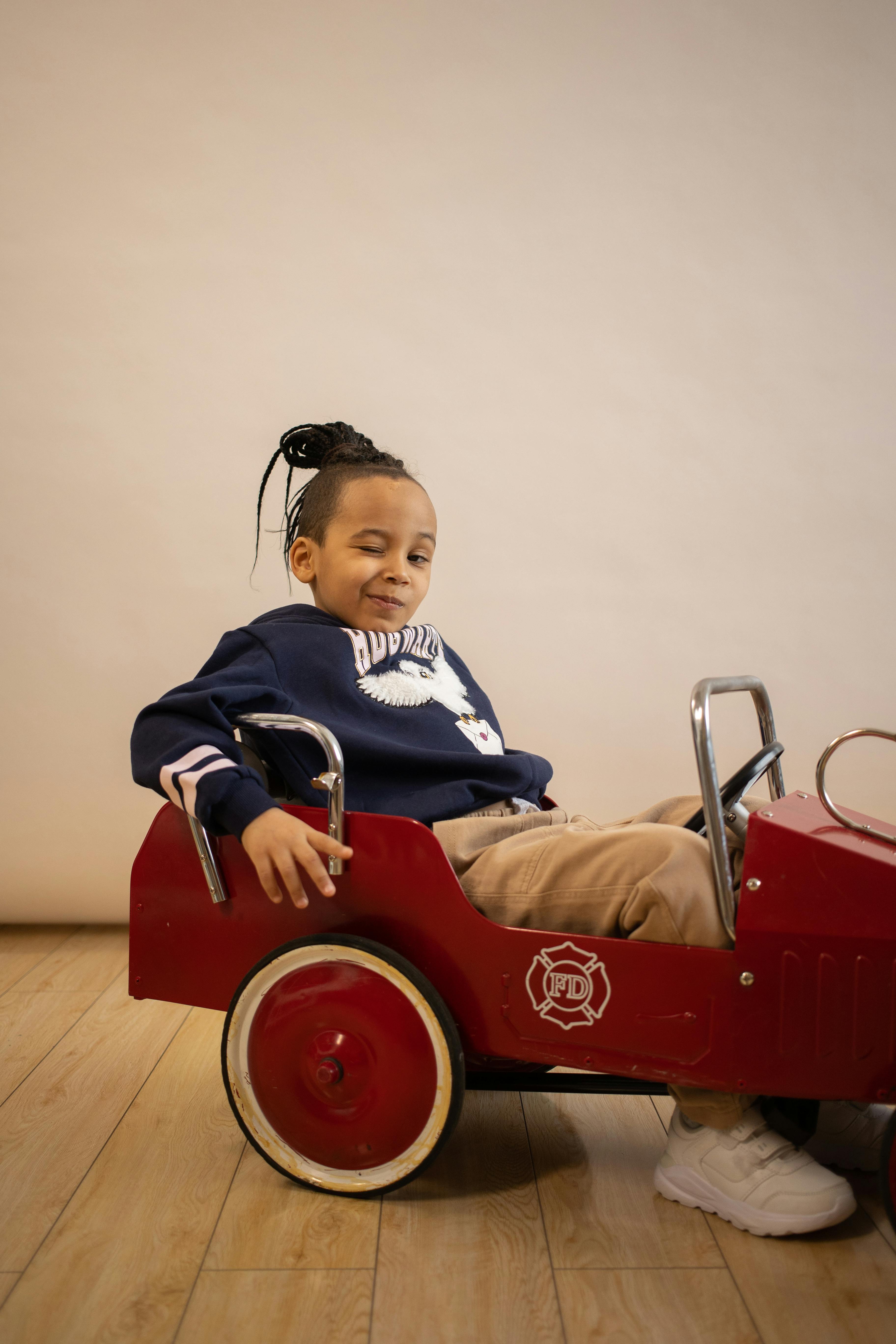 cool black boy in old fashioned velomobile