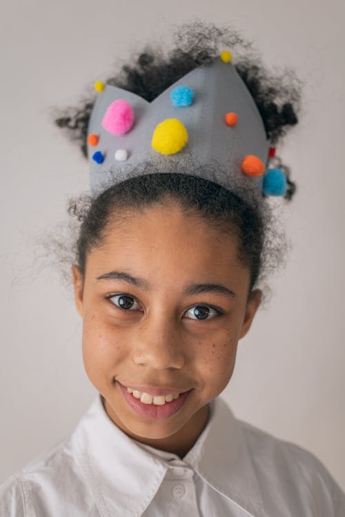 Cheerful black girl wearing crown
