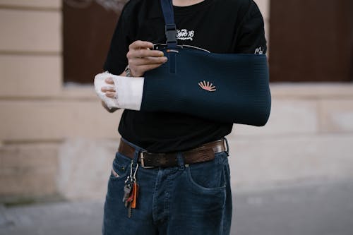 Free Person with Blue Bandage on his Injured Arm  Stock Photo