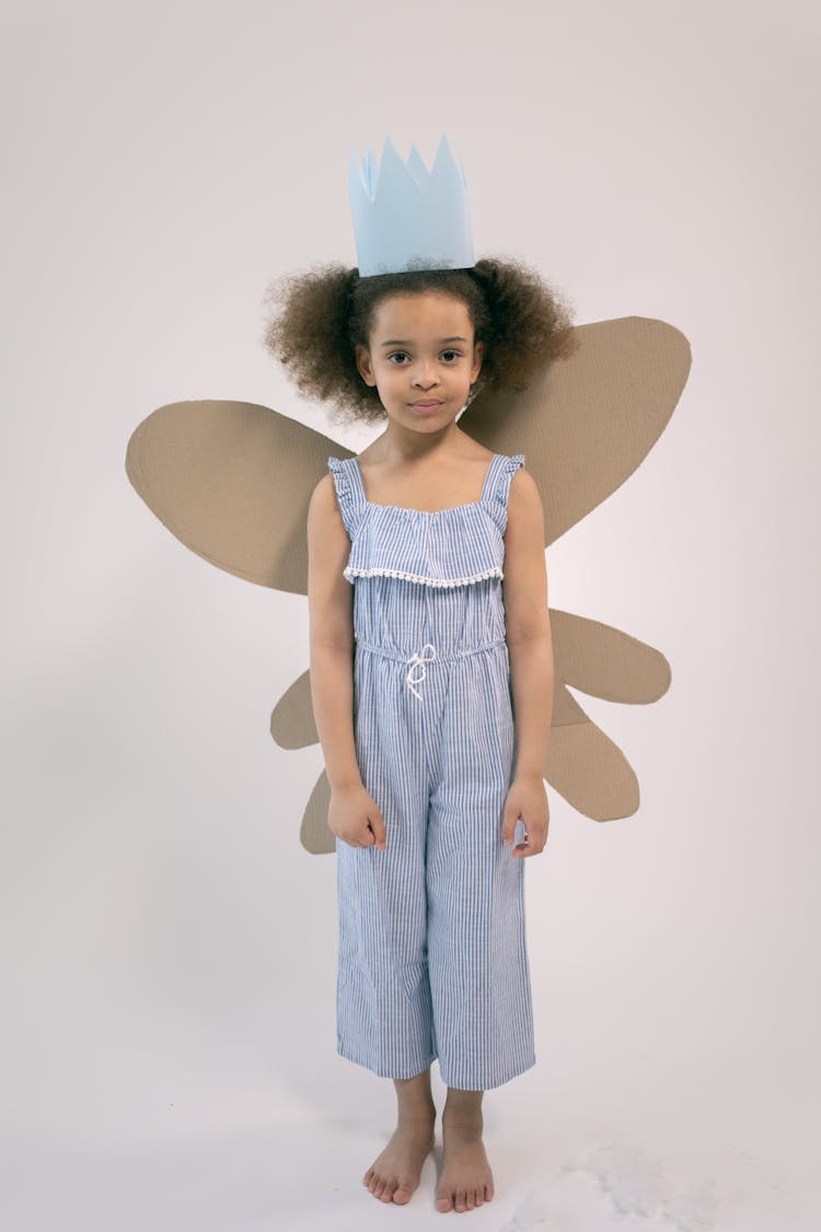 Cute Girl With Crown And Cardboard Wings