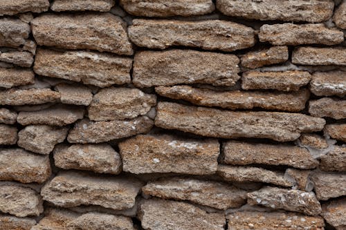 Backdrop of dry stone wall with uneven surface