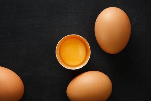 Free Top view of whole and half of fresh chicken eggs with yolk representing uniqueness concept Stock Photo