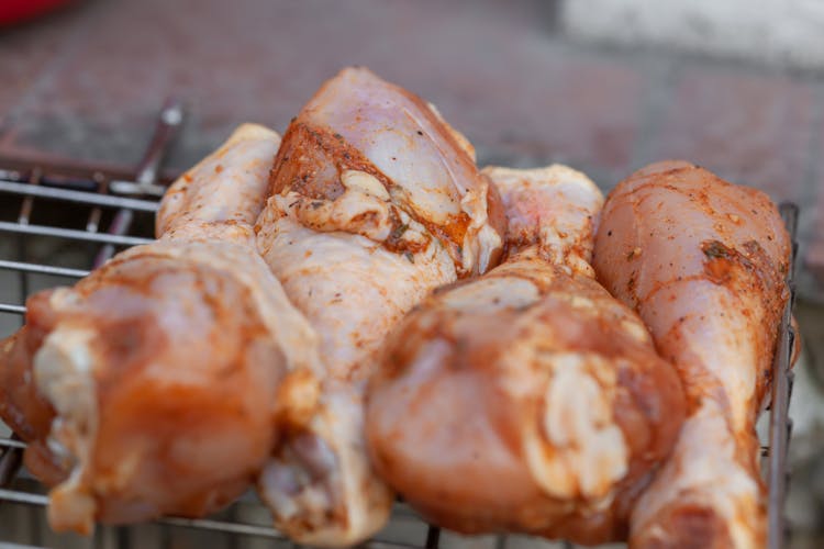 Raw Chicken Legs Placed On Grill Grate