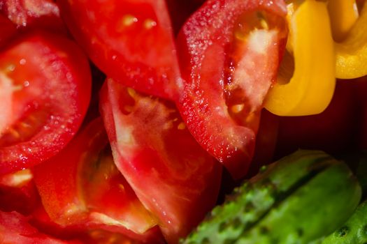 High angle of tasty ripe tomatoes and cucumbers placed near sweet yellow pepper