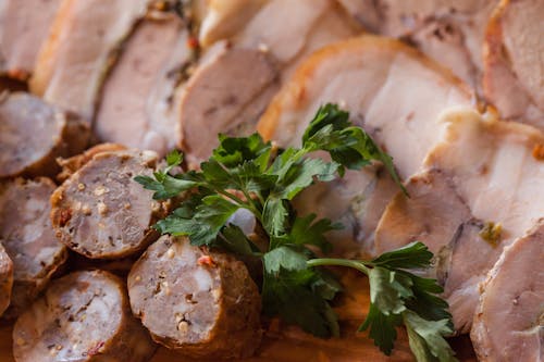 Free From above of tasty sliced sausage and meat placed on plate in daytime Stock Photo