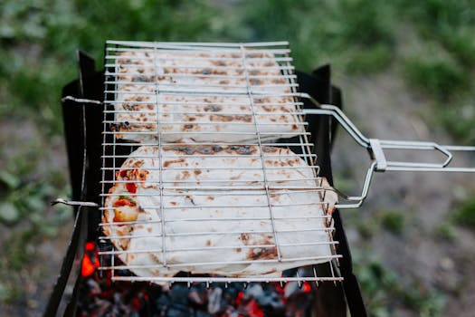 Delicious wraps being grilled on a barbecue outdoors, perfect for a summer picnic.