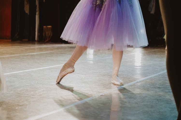 Ballerina Dancing On Stage During Concert