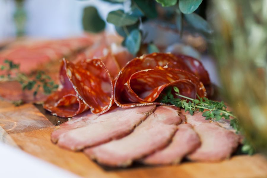 Salami slices and meat on a board