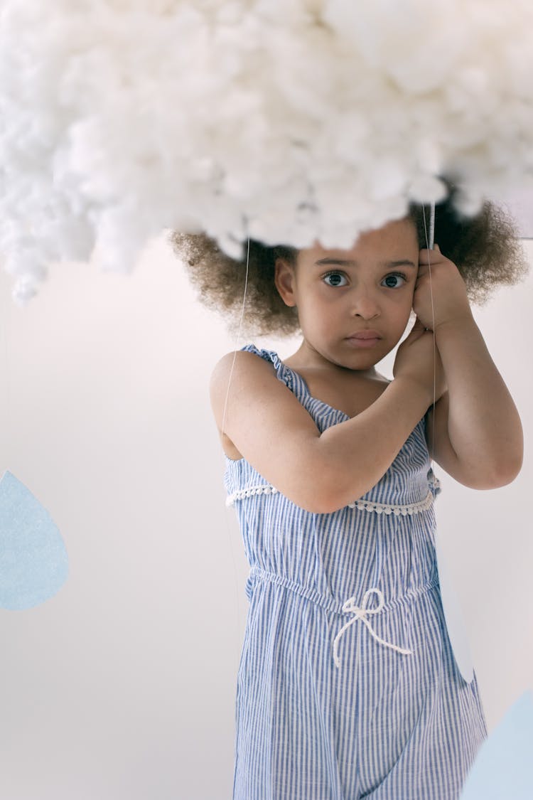 Pretty Child In Blue Dress Under Cotton Cloud