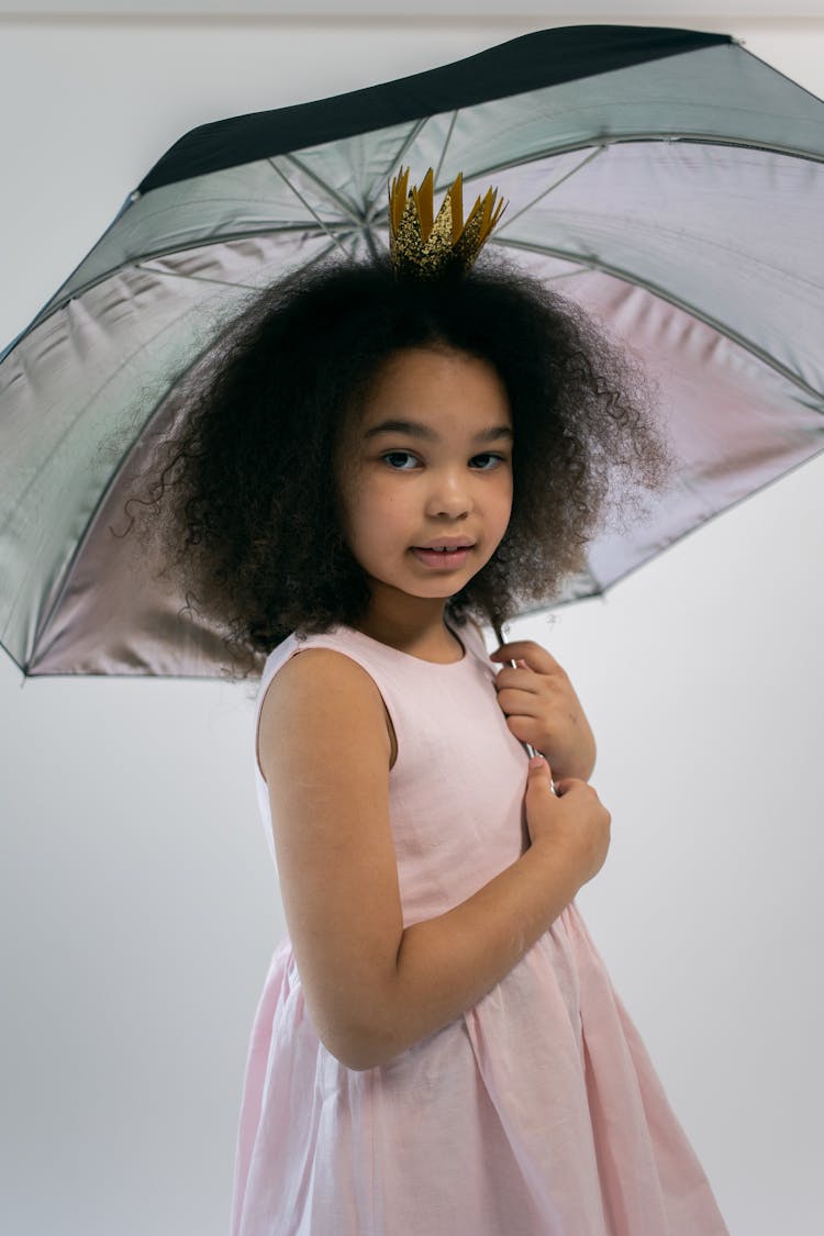 Cute Little Black Girl With Umbrella In Princess Costume Looking At Camera