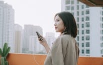 Female Holding a Small Black Cellphone