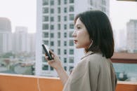 Woman with a Beige Blazer Listening to Music