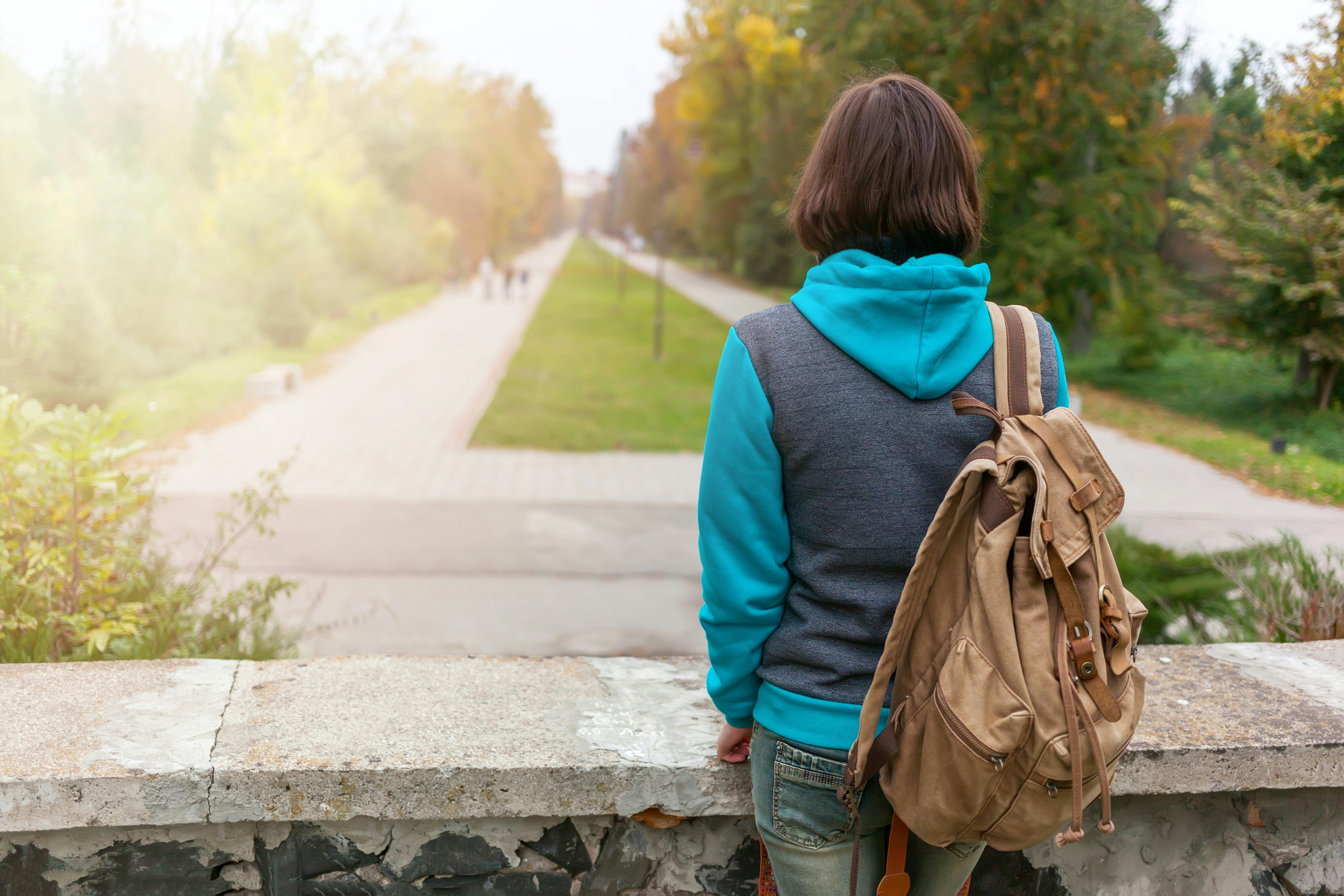 Person With a Brown Backpack and Wearing a Black Hoodie · Free Stock Photo