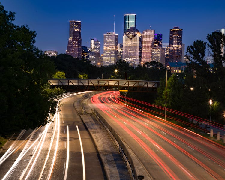 An Aerial Photography Of City Buildings At Night Near The Road